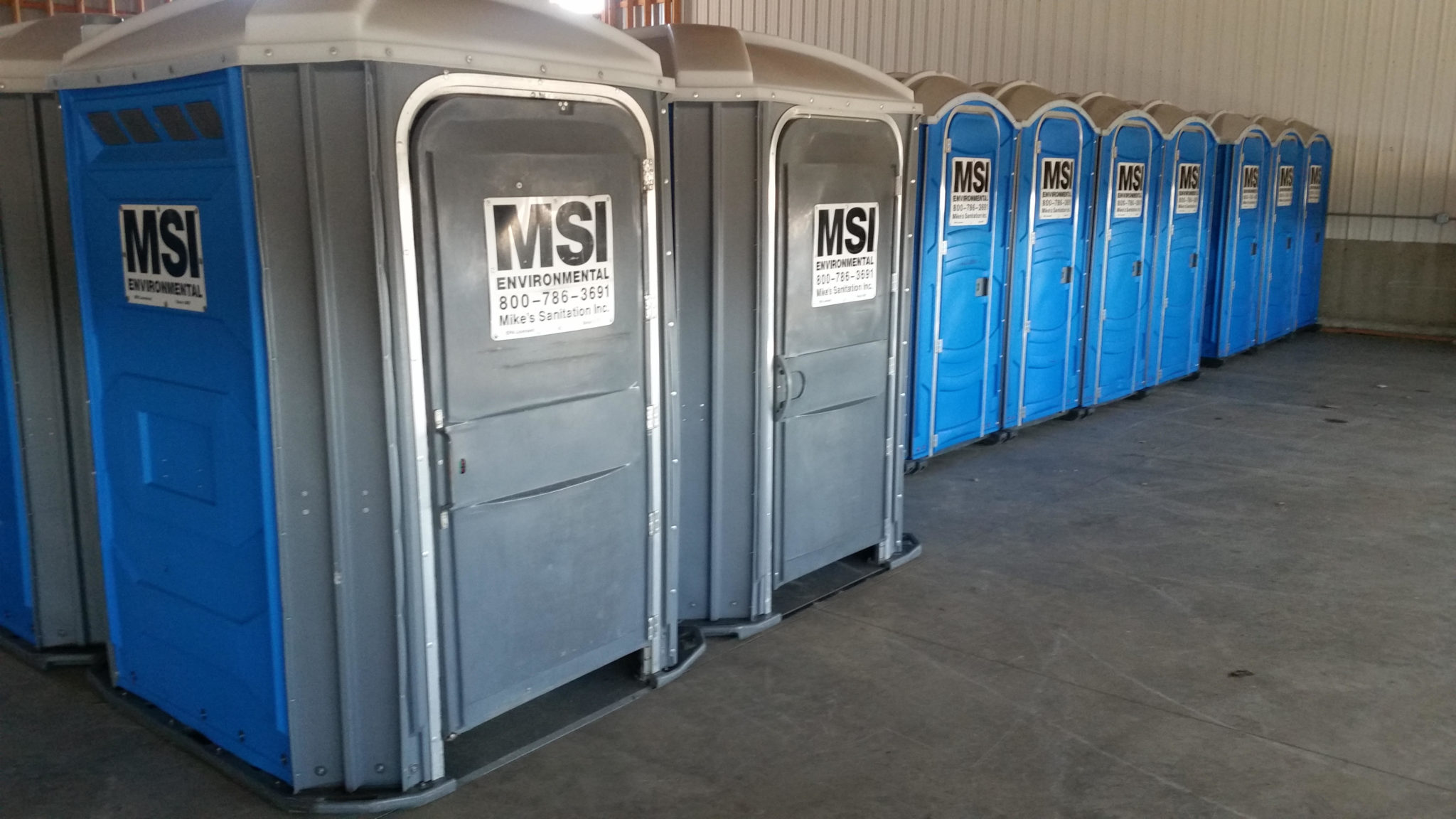 Rows of Mike’s Sanitation portable restrooms prepared for delivery to an outdoor event in ohio