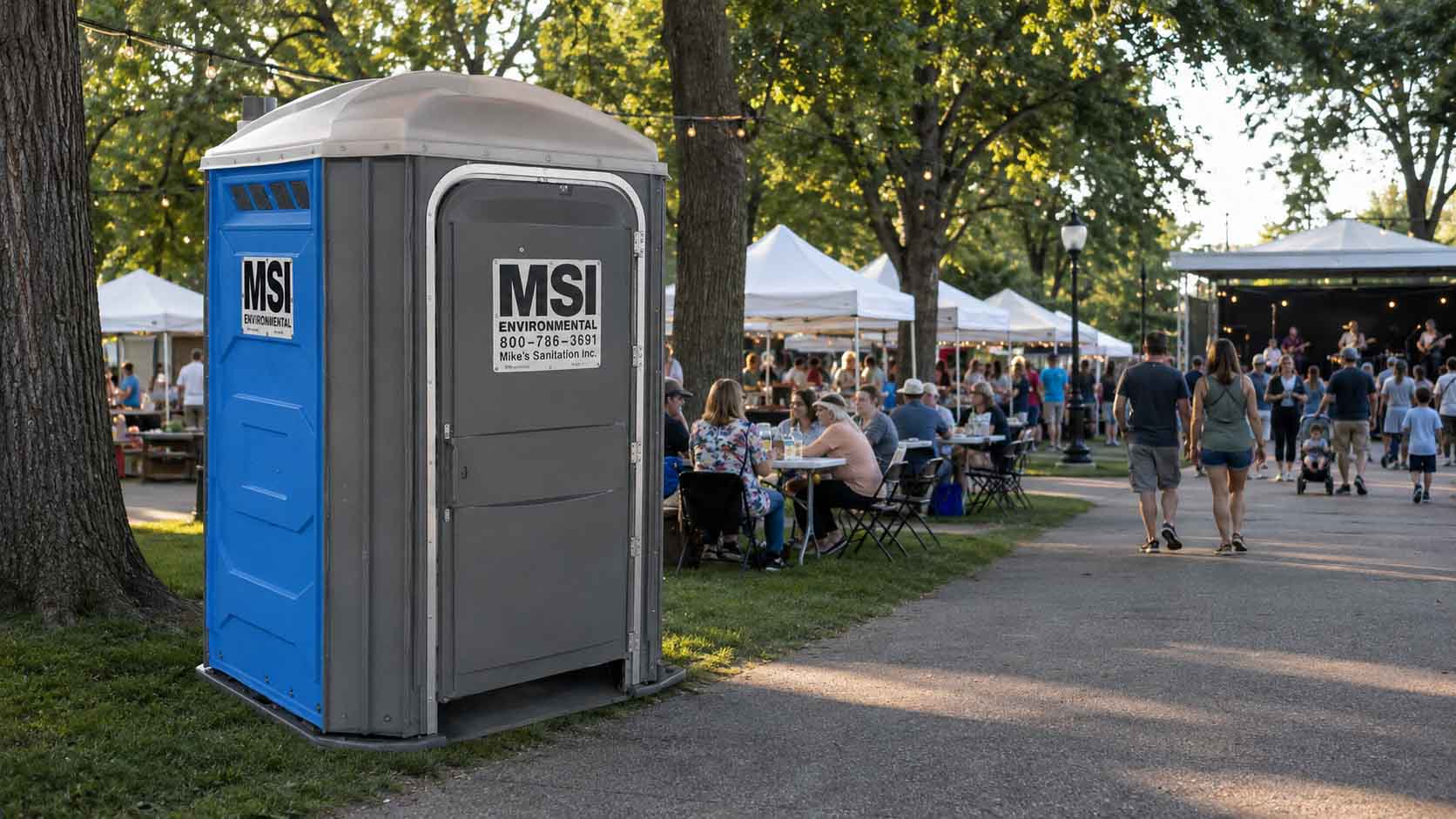 Portable restroom near guests at an outdoor event